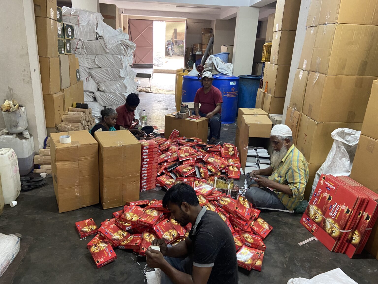 The Saba Fragrance team packing incense boxes at the factory